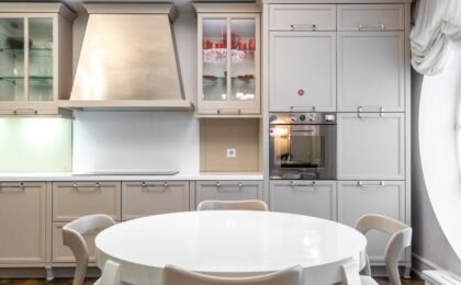 Modern kitchen design for family homes with a round dining table and beige cabinets